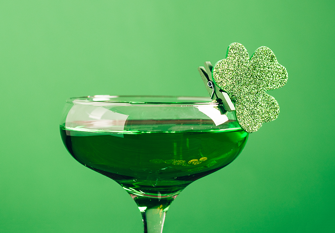 Green cocktail with shamrock on rim